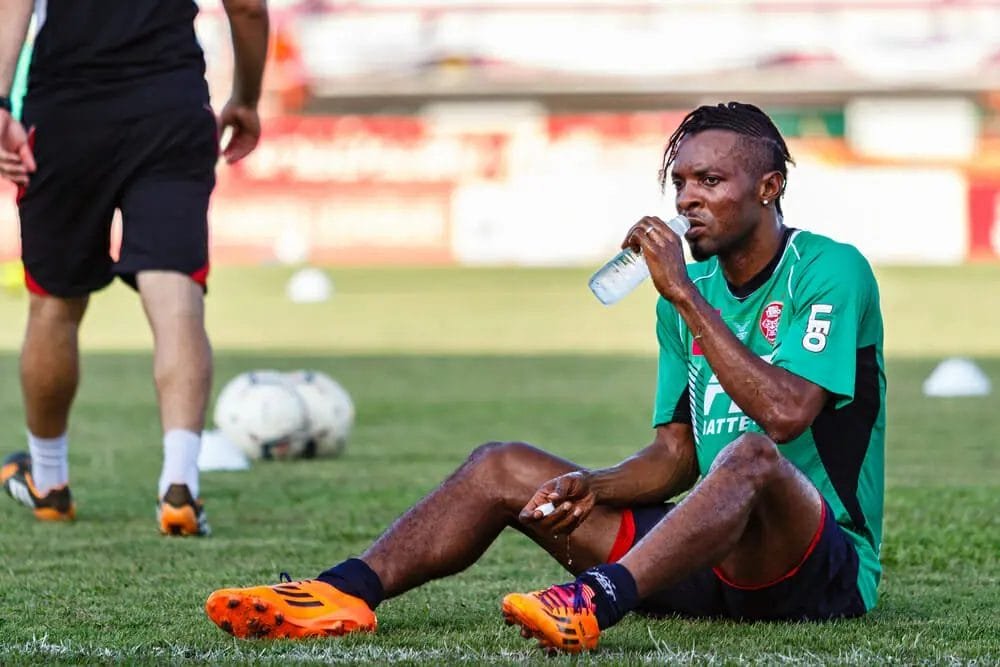 Football Player on pitch drinking water